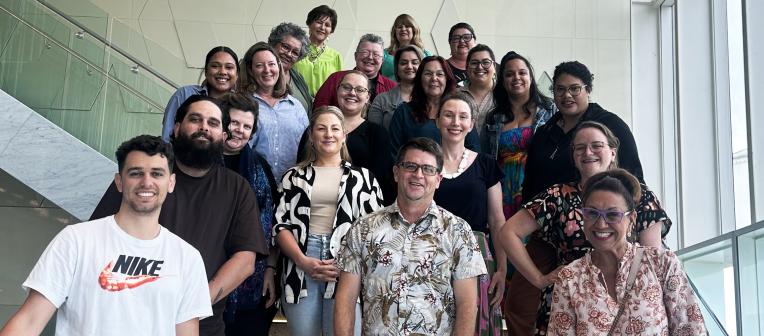 Staff group smiling on stairs
